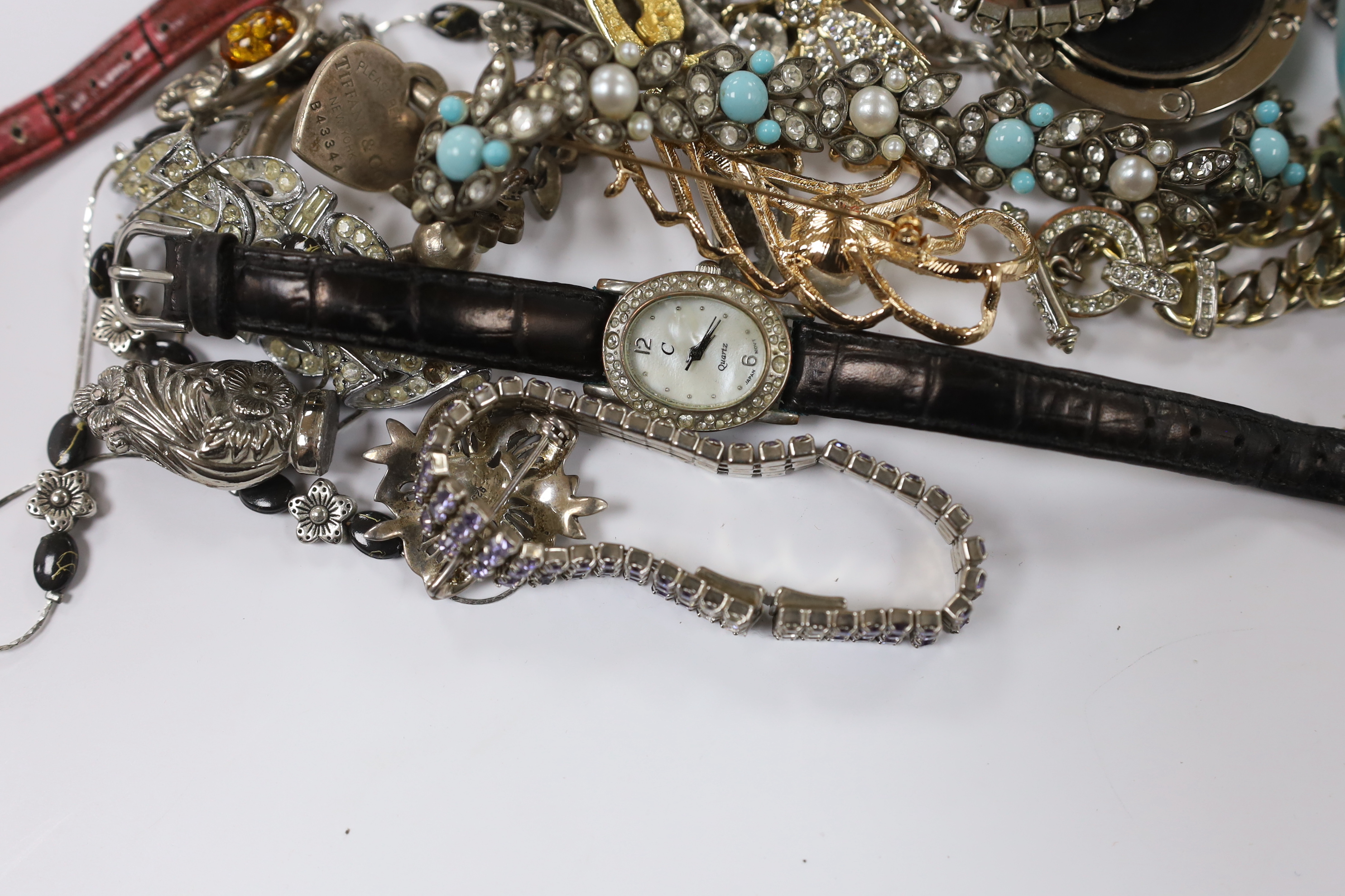 A group of assorted costume jewellery including marcasite and paste set, a Tiffany & Co sterling key ring, a 925 and amber set elephant brooch, blue agate bracelet, wrist watches, travelling watch, etc.